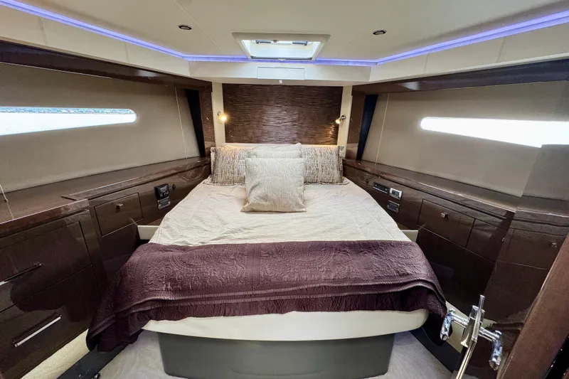 Orion Yacht Photos Pics Luxurious bedroom interior of 2018 Carver C52 Coupe yacht with elegant wood finishes.