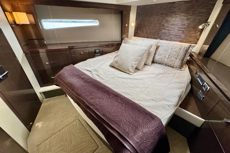 Orion Yacht Photos Pics Luxurious bedroom interior of 2018 Carver C52 Coupe yacht with elegant bedding and modern design.