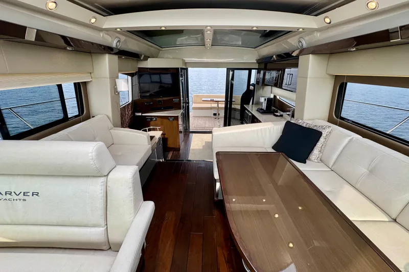 Orion Yacht Photos Pics Luxurious interior of 2018 Carver C52 Coupe yacht with elegant seating and ocean view.