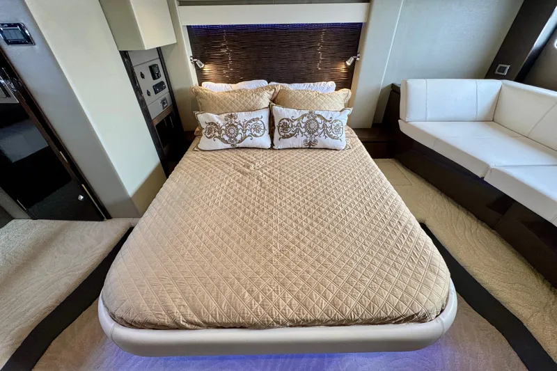 Orion Yacht Photos Pics Luxurious bedroom interior of 2018 Carver C52 Coupe yacht with elegant bedding and seating.