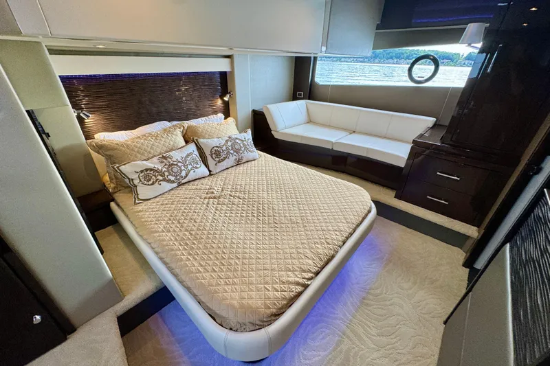 Orion Yacht Photos Pics Luxurious bedroom interior of 2018 Carver C52 Coupe yacht with elegant bedding and seating.