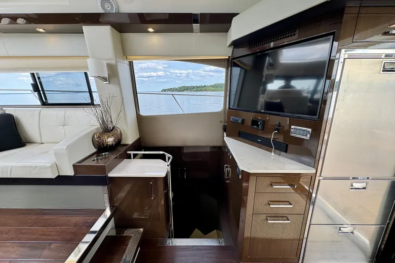 Orion Yacht Photos Pics Luxurious interior of 2018 Carver C52 Coupe yacht with modern amenities and scenic water view.