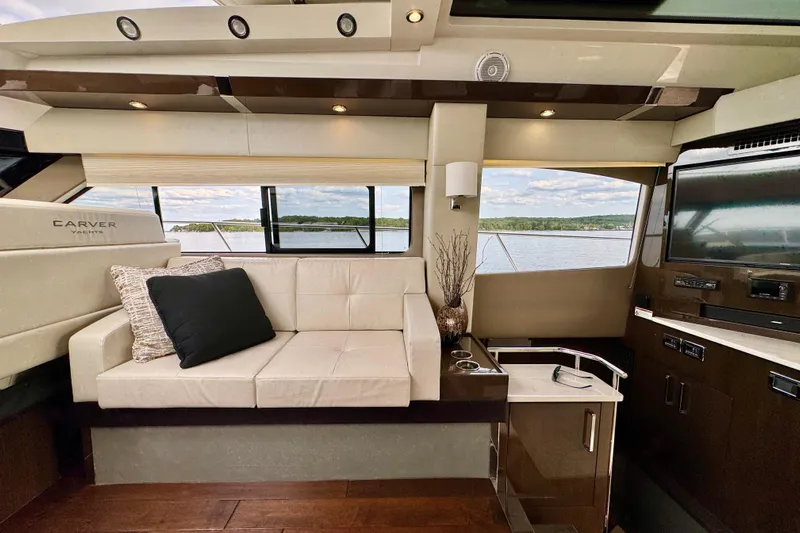 Orion Yacht Photos Pics Luxurious interior of 2018 Carver C52 Coupe yacht with elegant seating and scenic window view.