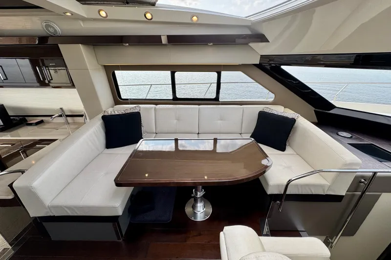 Orion Yacht Photos Pics Luxurious interior of 2018 Carver C52 Coupe yacht with elegant seating and table.