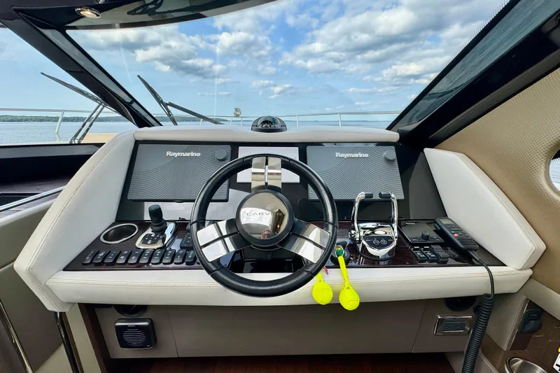 Orion Yacht Photos Pics Helm of 2018 Carver C52 Coupe with Raymarine navigation displays and steering wheel.