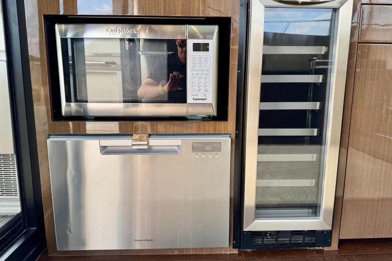 Orion Yacht Photos Pics Built-in microwave, dishwasher, and wine cooler in 2018 Carver C52 Coupe yacht kitchen.
