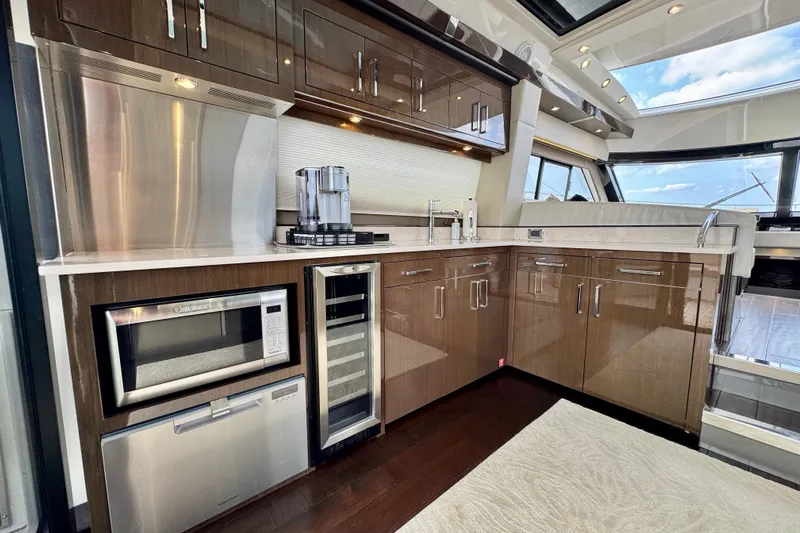 Orion Yacht Photos Pics Luxurious kitchen interior of 2018 Carver C52 Coupe yacht with modern appliances.