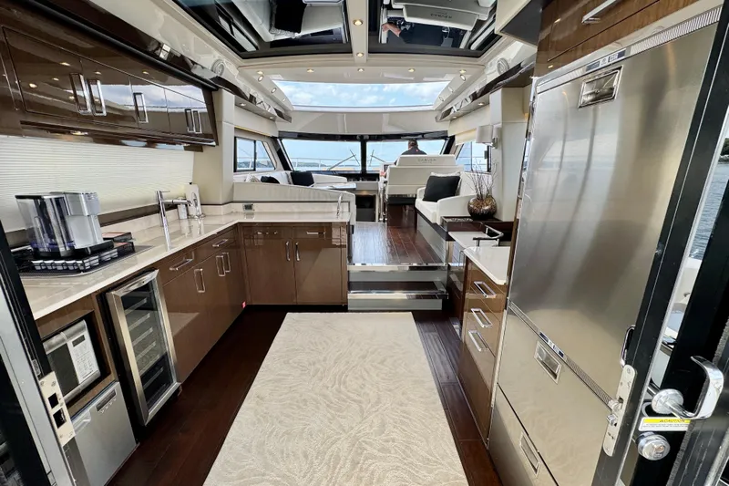 Orion Yacht Photos Pics Luxurious interior of 2018 Carver C52 Coupe yacht with modern kitchen and seating area.