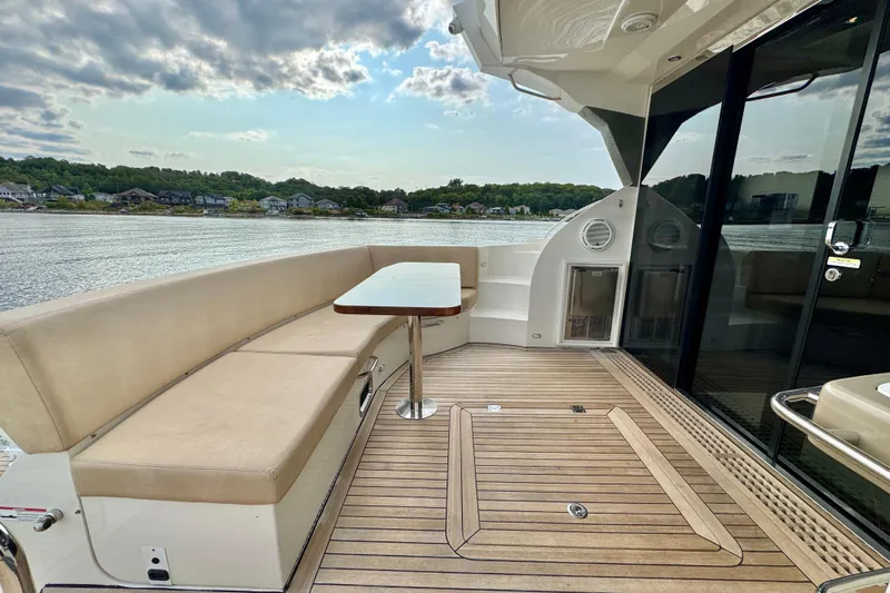 Orion Yacht Photos Pics Luxurious 2018 Carver C52 Coupe yacht deck with seating and scenic waterfront view.