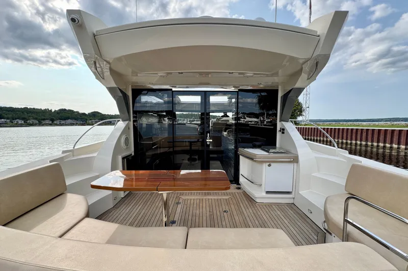 Orion Yacht Photos Pics 2018 Carver C52 Coupe yacht with spacious deck, seating, and outdoor kitchenette.