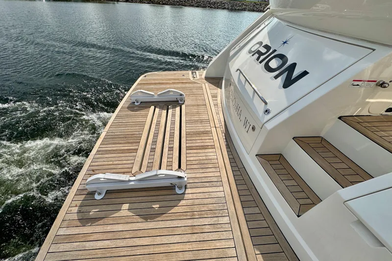Orion Yacht Photos Pics Carver C52 Coupe 2018 yacht with wooden deck and water view.