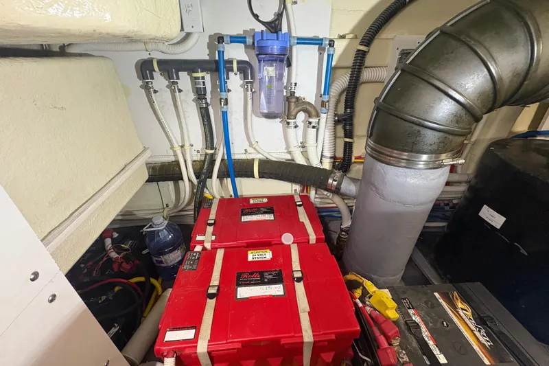 Orion Yacht Photos Pics Engine room of 2018 Carver C52 Coupe with batteries and plumbing system.