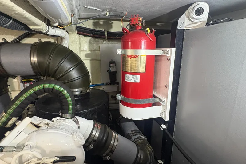 Orion Yacht Photos Pics Engine room of 2018 Carver C52 Coupe with fire extinguisher and ventilation system.