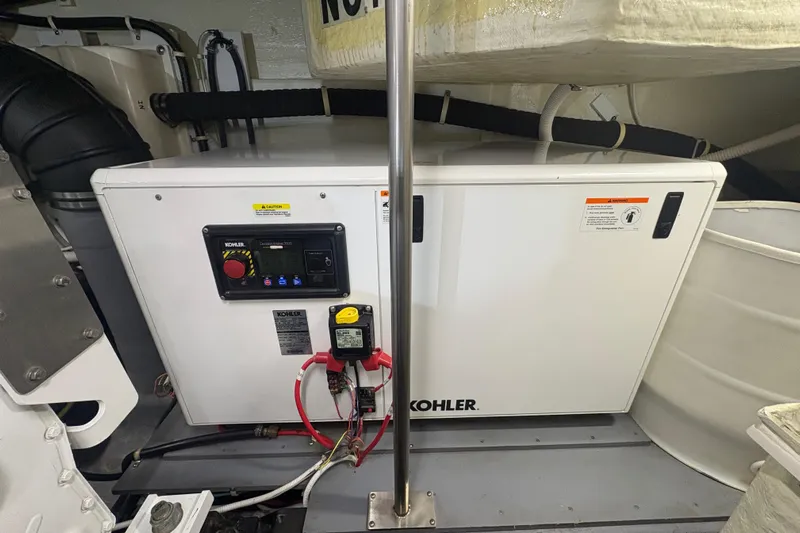 Orion Yacht Photos Pics Kohler generator in 2018 Carver C52 Coupe engine room, featuring control panel and wiring.