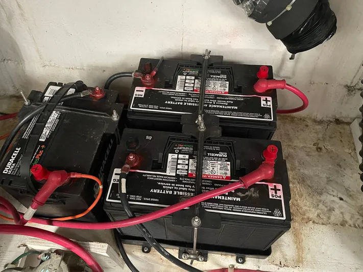  Yacht Photos Pics Batteries in a 2000 Carver 400 Express boat, connected with red and black cables.