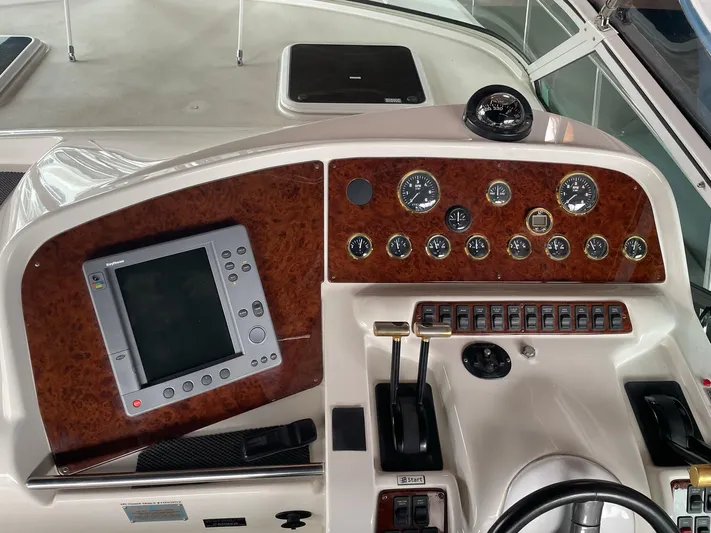  Yacht Photos Pics Control panel of a 2000 Carver 400 Express boat with gauges and navigation screen.