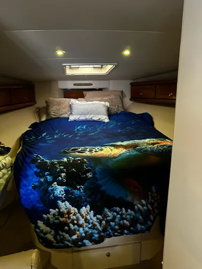  Yacht Photos Pics Cozy bedroom in 2000 Carver 400 Express yacht with ocean-themed bedding.