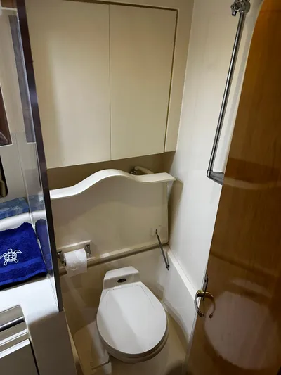  Yacht Photos Pics Bathroom interior of 2000 Carver 400 Express yacht, featuring toilet and shower.