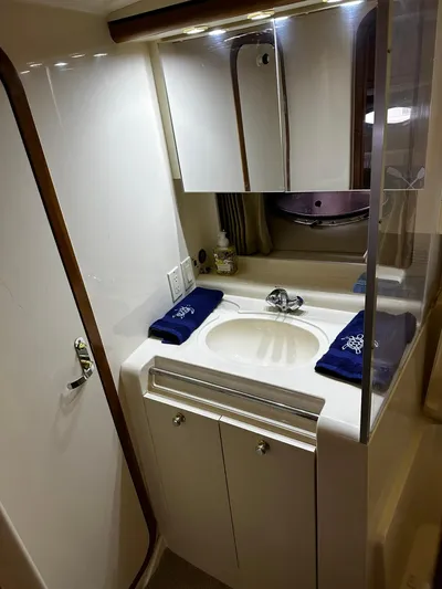  Yacht Photos Pics 2000 Carver 400 Express bathroom with sink, mirror, and storage cabinets.
