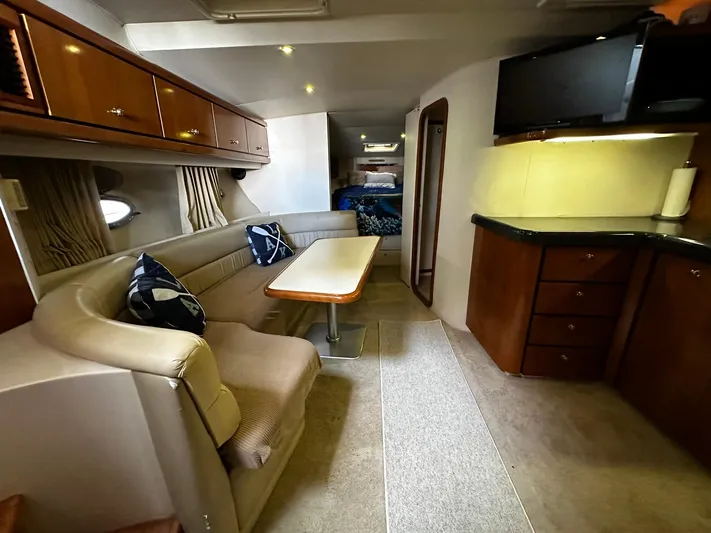  Yacht Photos Pics Interior of 2000 Carver 400 Express yacht with dining area and kitchenette.