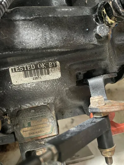  Yacht Photos Pics Close-up of a Carver 400 Express 2000 engine part with a "Tested OK By" label.
