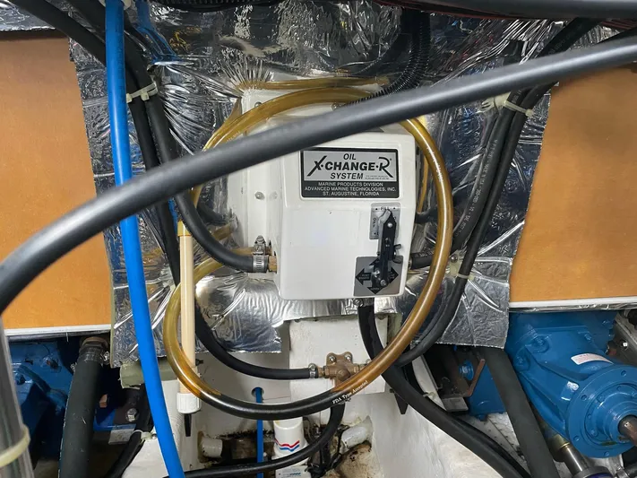  Yacht Photos Pics Engine room of 2000 Carver 400 Express with oil changer system and various hoses.