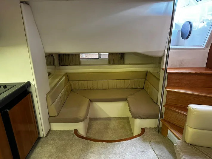  Yacht Photos Pics Interior of 2000 Carver 400 Express yacht with cozy seating area and wooden stairs.