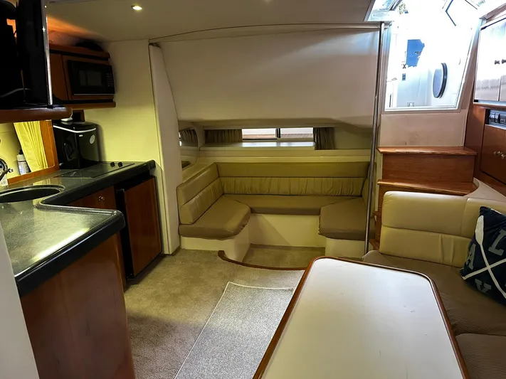  Yacht Photos Pics Interior of 2000 Carver 400 Express yacht with cozy seating and kitchenette.