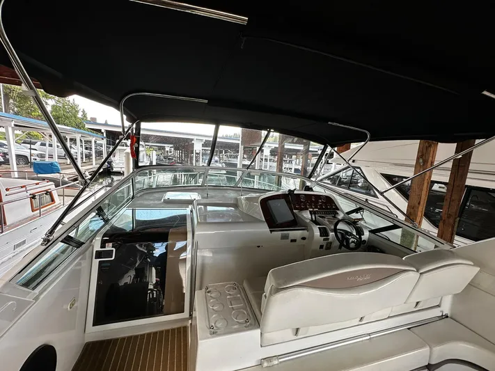  Yacht Photos Pics 2000 Carver 400 Express yacht interior with helm, seating, and canopy.