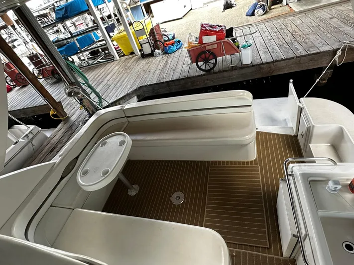  Yacht Photos Pics Carver 400 Express 2000 yacht deck with seating and table at marina.