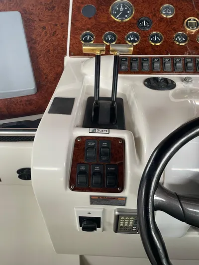  Yacht Photos Pics Control panel of a 2000 Carver 400 Express boat with gauges and switches.