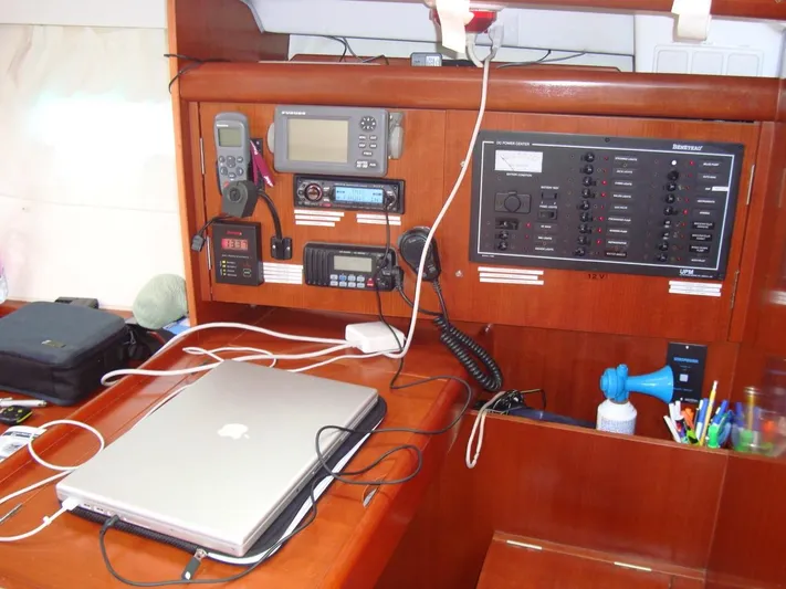 Monlove Yacht Photos Pics Navigation station on 2007 Beneteau Oceanis Clipper 393 with electronics and laptop.