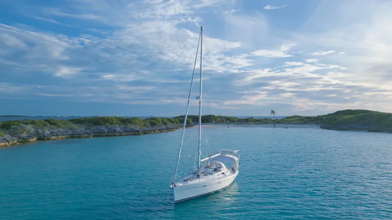 Monlove Yacht Photos Pics Sailboat Beneteau Oceanis Clipper 393, 2007, anchored in serene turquoise waters under a blue sky.