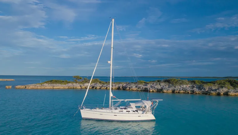 Monlove Yacht Photos Pics Beneteau Oceanis Clipper 393 sailboat, 2007 model, anchored in serene blue waters.