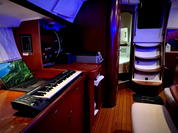 Monlove Yacht Photos Pics Interior of 2007 Beneteau Oceanis Clipper 393 with keyboard and laptop on wooden table.