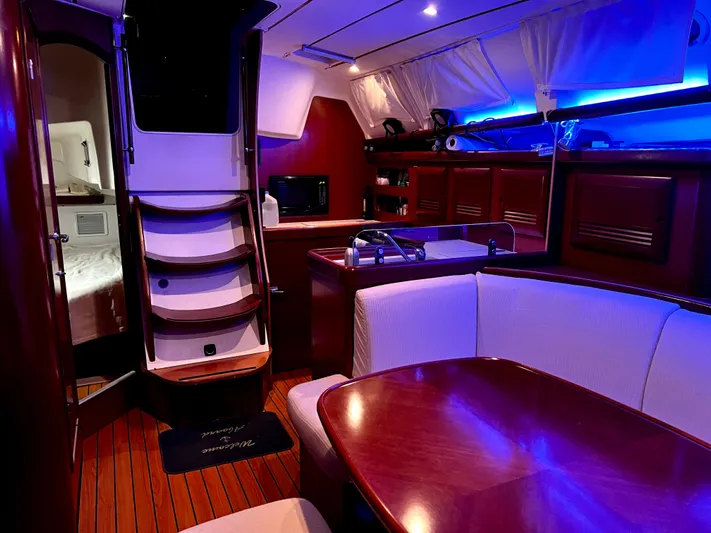 Monlove Yacht Photos Pics Interior of 2007 Beneteau Oceanis Clipper 393 yacht with elegant wood finish and ambient lighting.