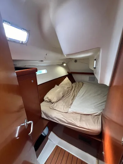 Monlove Yacht Photos Pics Cozy cabin interior of 2007 Beneteau Oceanis Clipper 393 sailboat with wooden finishes.