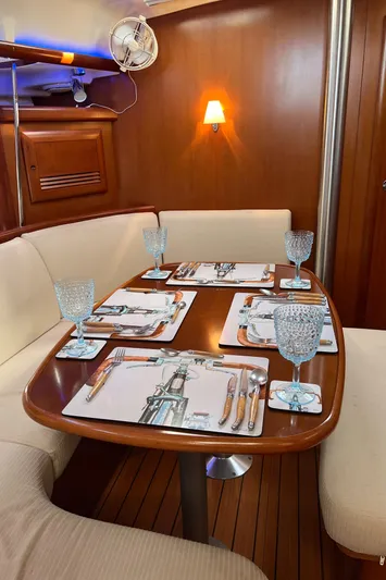 Monlove Yacht Photos Pics Dining area in 2007 Beneteau Oceanis Clipper 393 yacht, set with elegant tableware.