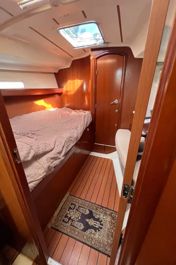 Monlove Yacht Photos Pics Interior cabin of 2007 Beneteau Oceanis Clipper 393 with wooden finish and cozy bed.