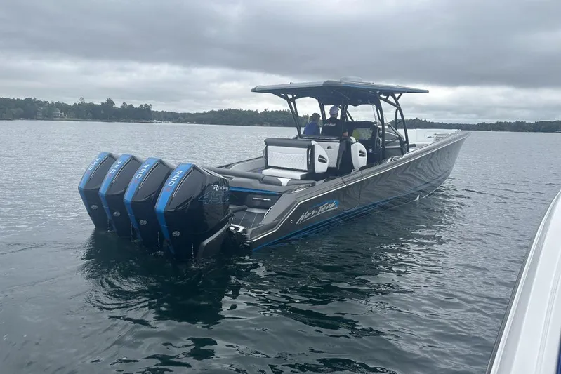  Yacht Photos Pics 2022 Nor-Tech 390 Sport boat with quad engines on a calm lake.