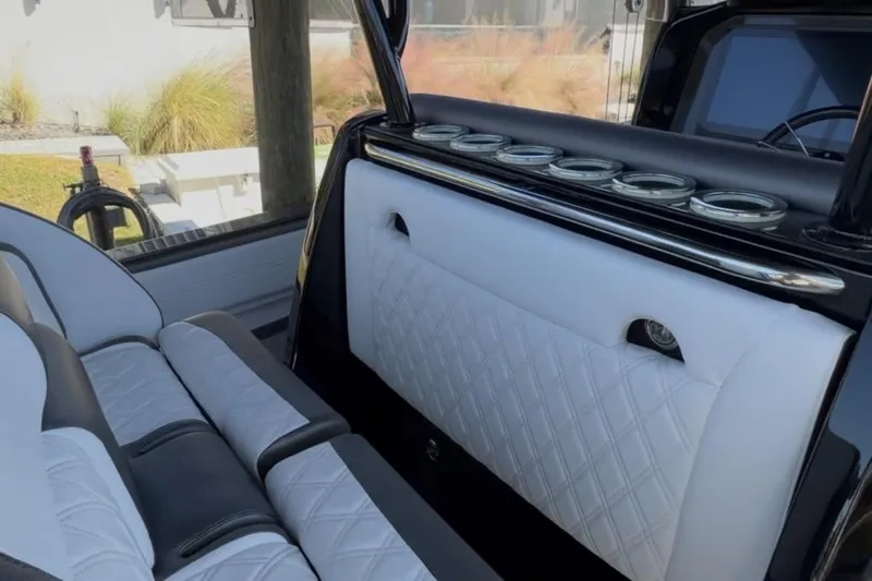  Yacht Photos Pics Luxurious interior of 2022 Nor-Tech 390 Sport boat with white quilted seating.