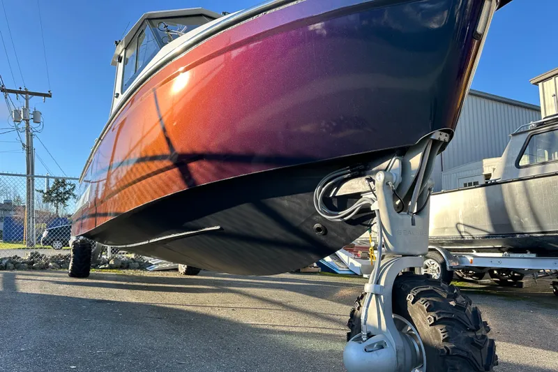  Yacht Photos Pics 2026 Sealegs 8.5m Cabin boat with amphibious wheels, parked outdoors.