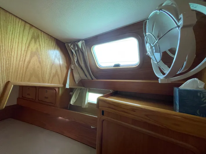 Chandelle Yacht Photos Pics Cozy cabin interior of 2008 Alubat OVNI 435 sailboat with wooden finish and window.