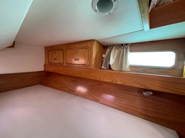 Chandelle Yacht Photos Pics Cozy cabin interior of 2008 Alubat OVNI 435 sailboat with wooden storage and window.