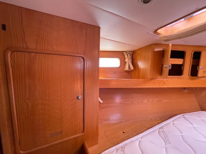 Chandelle Yacht Photos Pics Interior cabin of 2008 Alubat OVNI 435 sailboat with wooden cabinetry and mattress.
