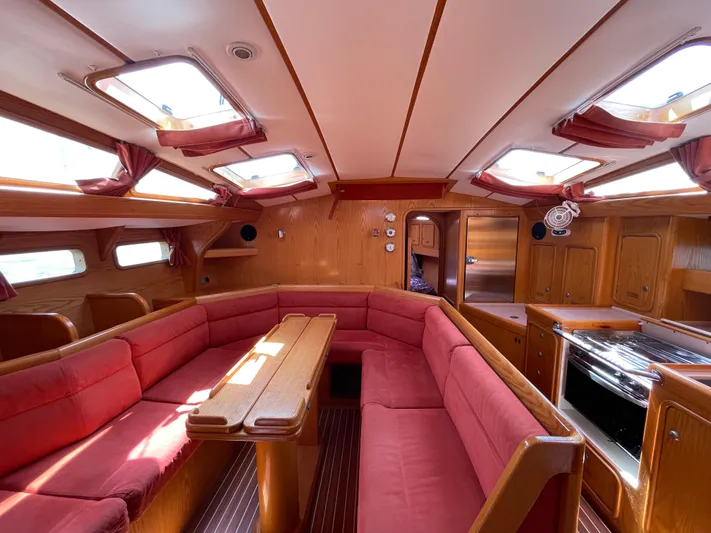 Chandelle Yacht Photos Pics Interior of 2008 Alubat OVNI 435 yacht with red seating and wooden finishes.