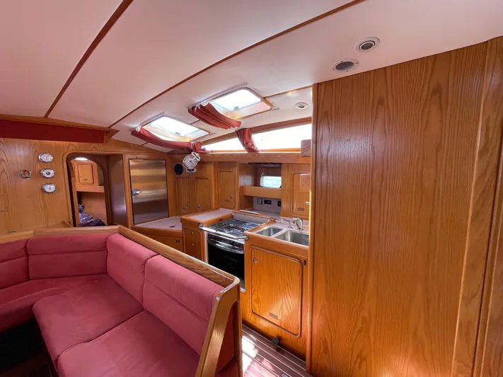 Chandelle Yacht Photos Pics Interior of 2008 Alubat OVNI 435 yacht with wood finish and red seating.