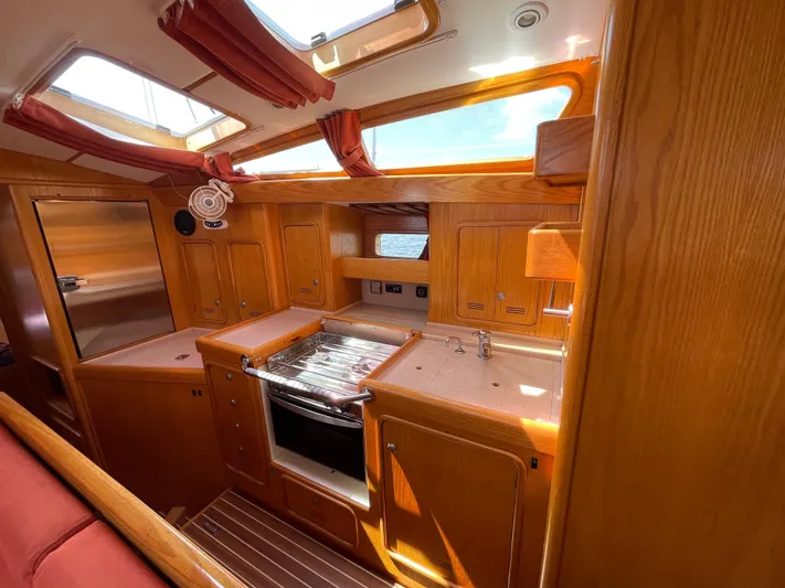 Chandelle Yacht Photos Pics Interior of 2008 Alubat OVNI 435 yacht with wooden cabinetry and modern kitchen amenities.