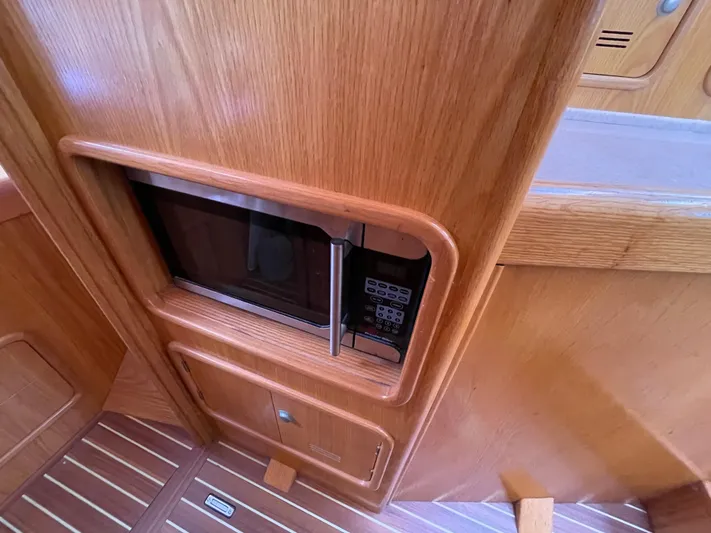 Chandelle Yacht Photos Pics Microwave in wooden cabinet on 2008 Alubat OVNI 435 yacht interior.