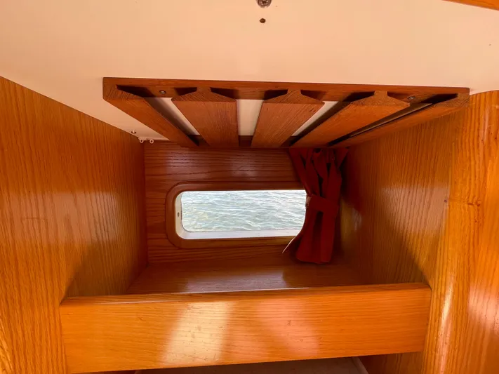 Chandelle Yacht Photos Pics Interior cabin of 2008 Alubat OVNI 435 sailboat with wooden finish and window.